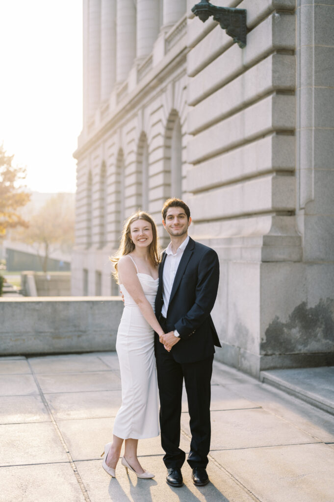 Couple posing outside the Old Courthouse in downtown Cleveland during a fall engagement session.