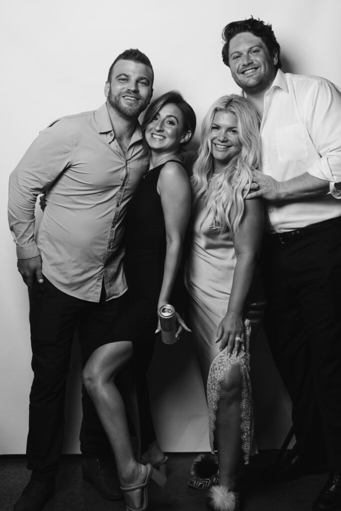 Group of guests laughing and posing together.