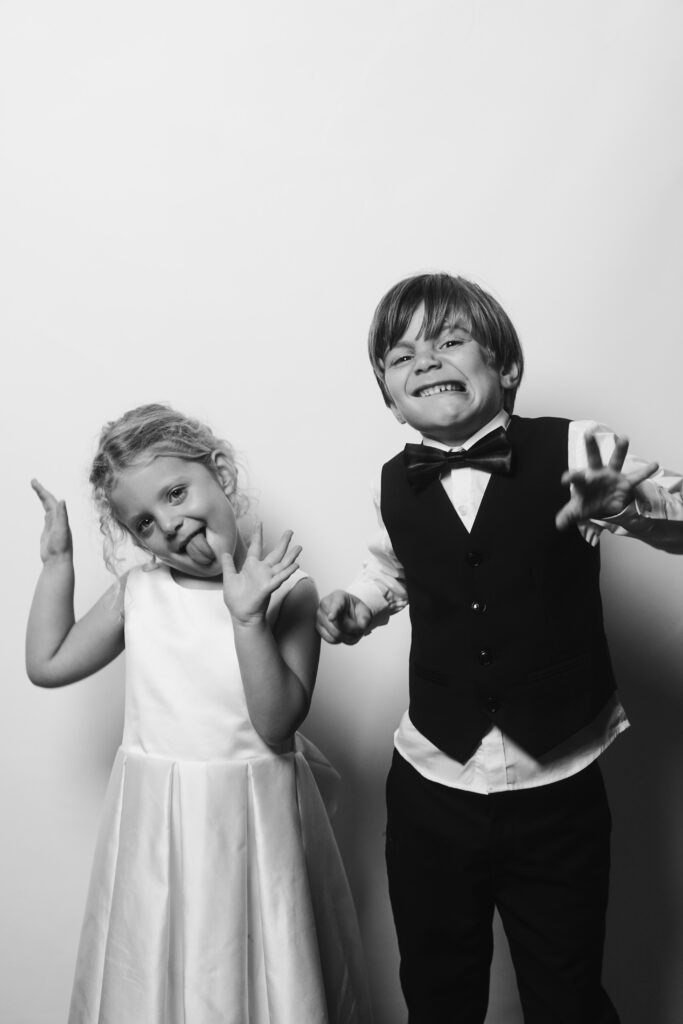 Flower girl and ring bearer making funny faces during guest portrait experience at Cleveland wedding.